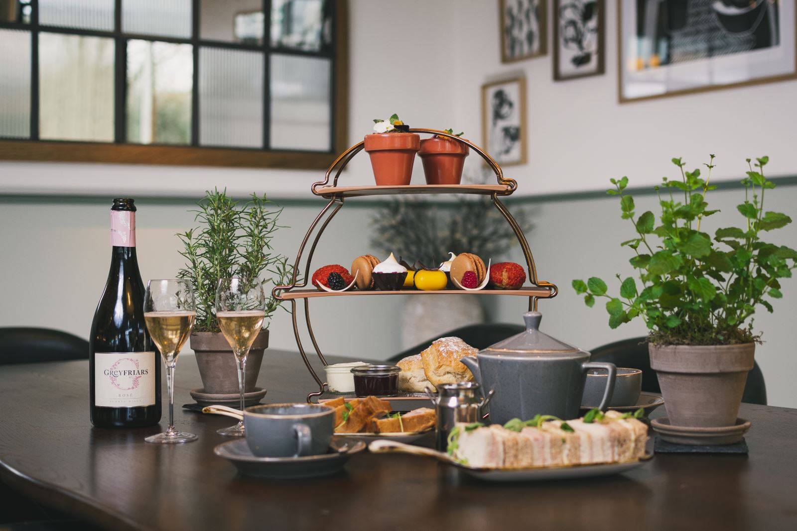 Afternoon tea beside a bottle and glasses of wine